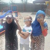 Children wearing eclipse glasses on the playground